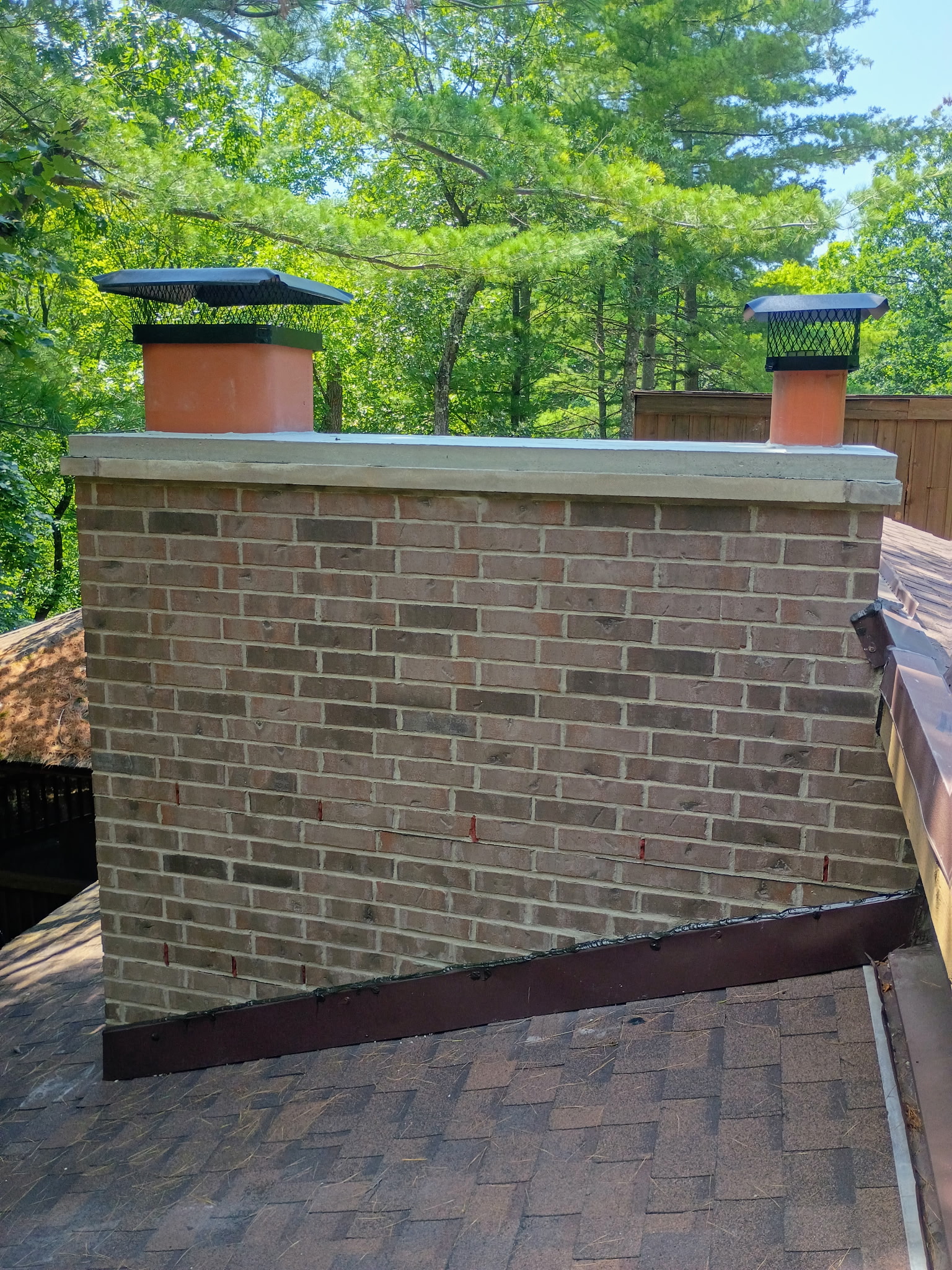 Brick chimney with new black caps and sealed crown