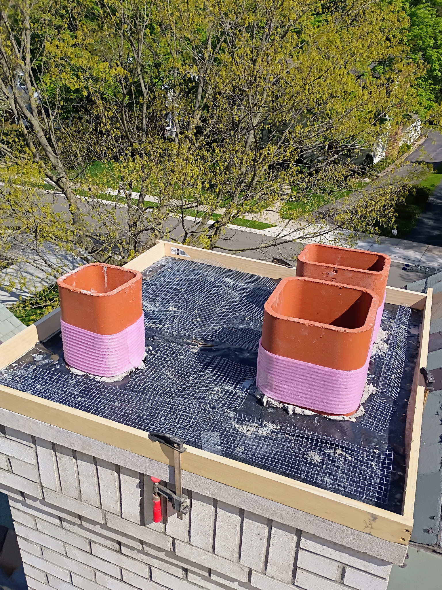Waterproofing membrane and mesh applied to chimney crown