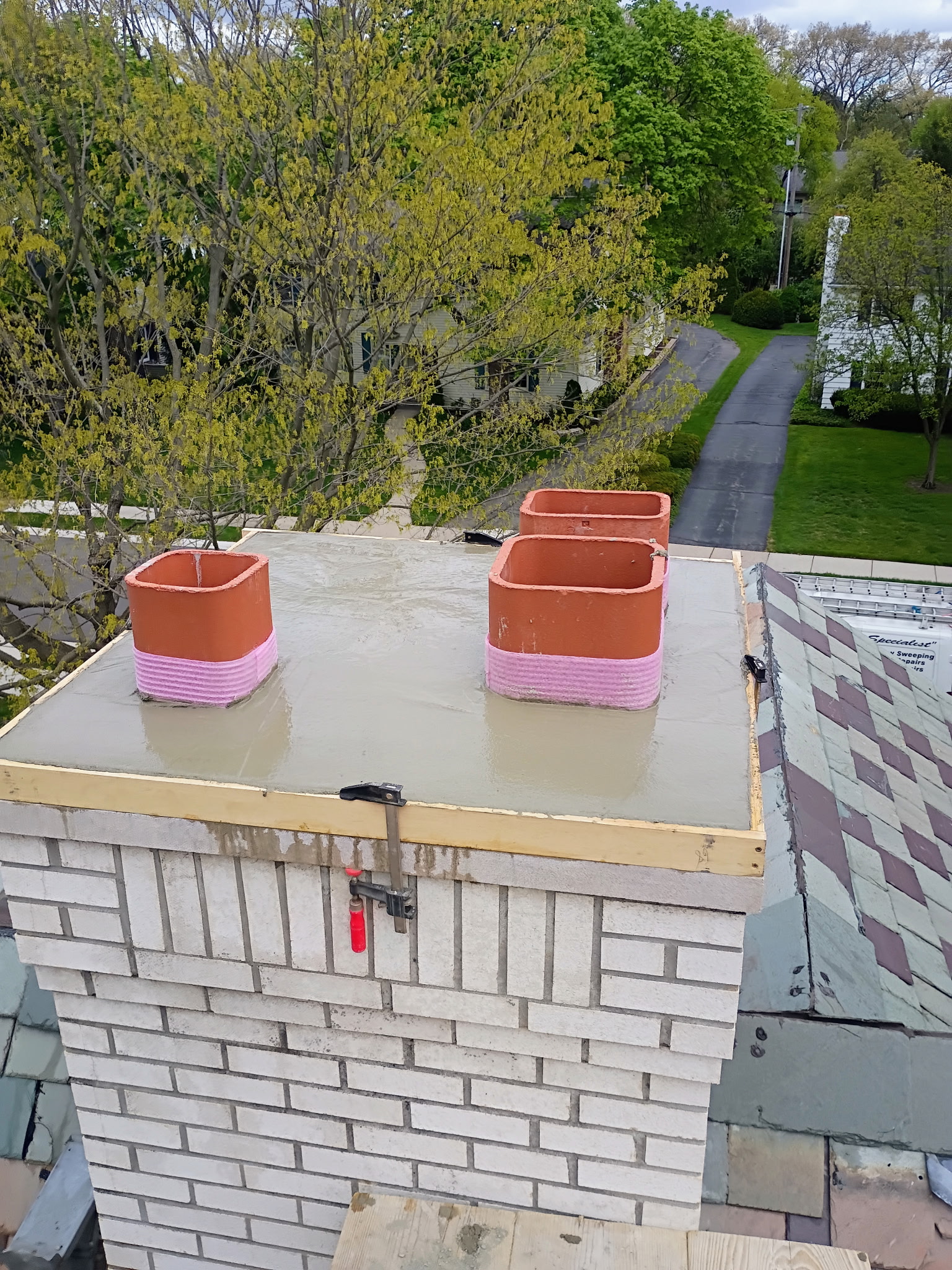 Freshly poured concrete chimney crown during waterproofing